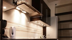 A modern kitchen with stainless steel appliances, a built-in oven, and a dishwasher. - Bridgestreet St Germain (Paris)