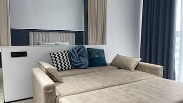 Family Apartment, City View | Living area | Flat-screen TV