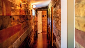 A narrow wooden hallway with a wooden door at the end. - New Converted 3BR, 2BA barn, in wild, wonderful West Virginia with AC, WiFi (Triadelphia)