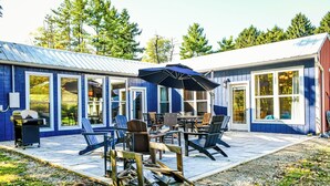 A blue building with large windows and a patio area with outdoor furniture. - New Converted 3BR, 2BA barn, in wild, wonderful West Virginia with AC, WiFi (Triadelphia)