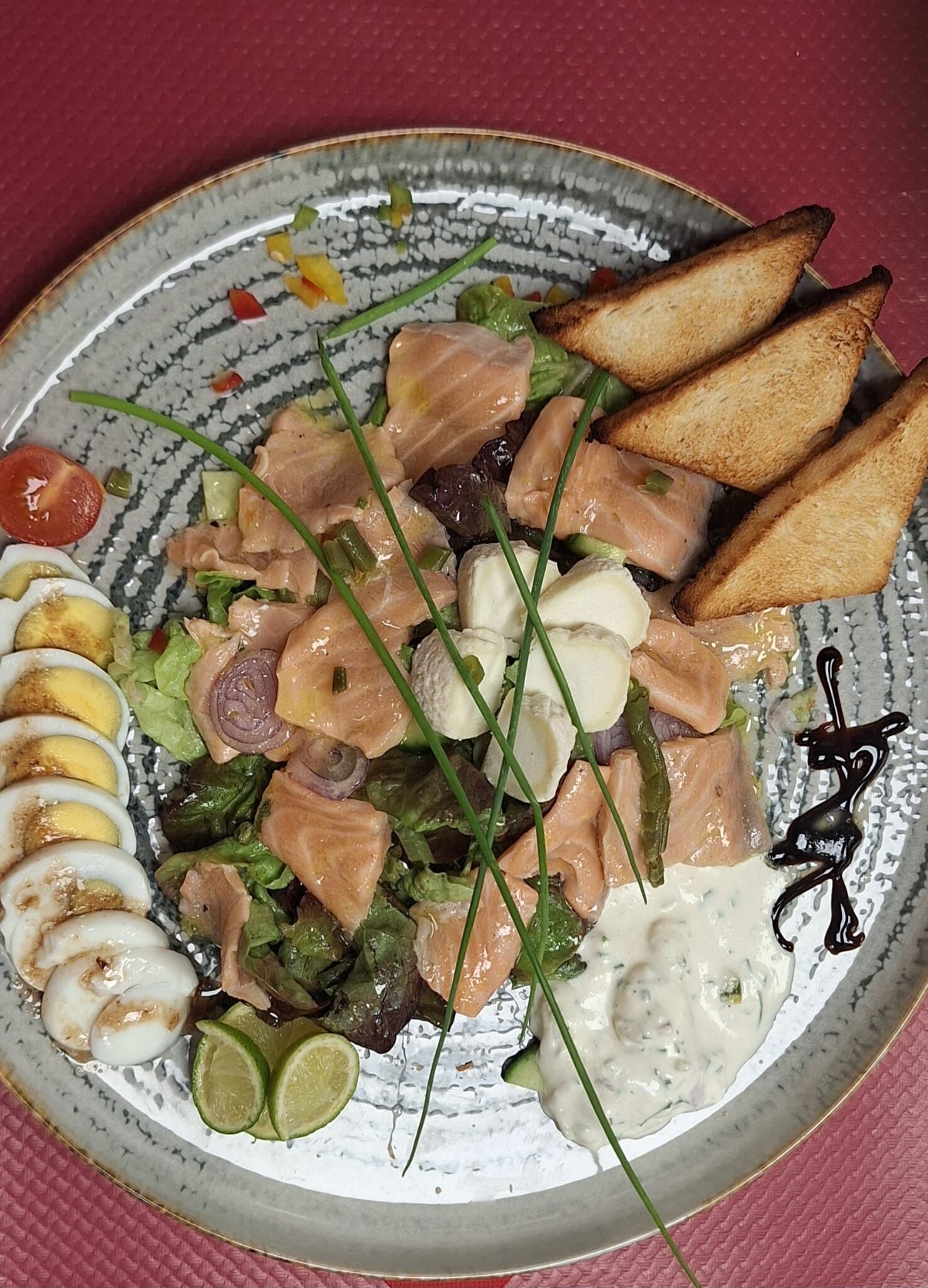 A plate with salmon, eggs, and vegetables.