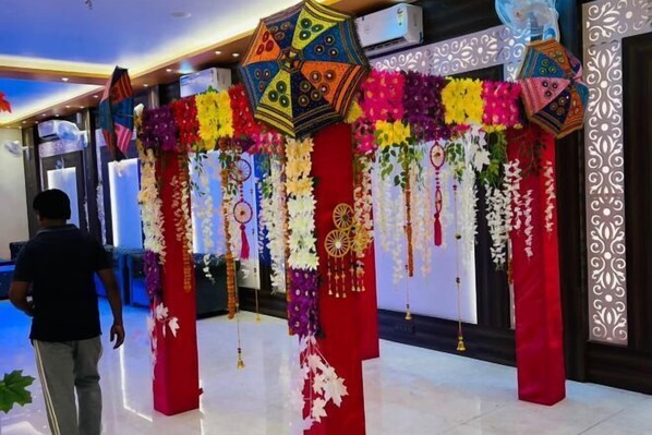 A decorated entrance with floral arrangements and hanging ornaments. - The Four Seasons Hotel (Kasba Sultanpur)