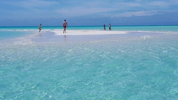 A beach with clear turquoise water and a sandy shore. - New Seaside Vacation Villa With Hotel Amenities v9 (Providenciales)