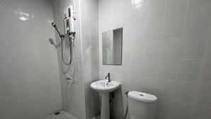 A modern bathroom with a toilet, sink, and shower. - Civilize apartment (Nonthaburi)