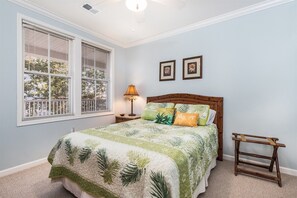 A bedroom with a bed, a nightstand, a lamp, and a window with blinds. - Sunset Island 2 Hidden Cove Way, Unit 2E (Ocean City)