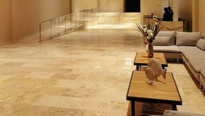 A spacious lobby with a marble floor, a staircase, and a seating area with sofas and a coffee table. - Eden Loft in beautiful Santa Marta Colombia, "The Pearl of the Americas" (Santa Marta)