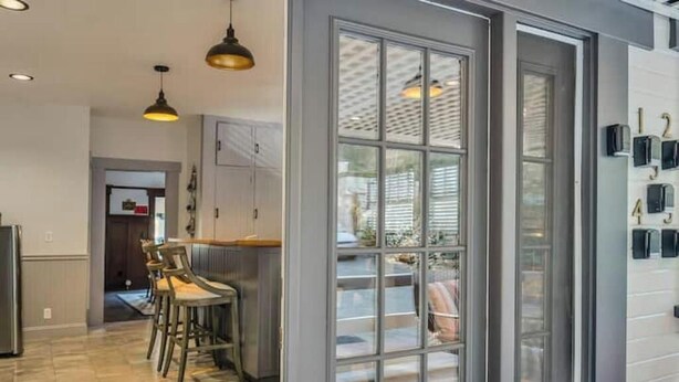 A modern kitchen with a bar area, large windows, and a view of the outdoors. - Romantic King Room Near Calistoga Spa & Hot Springs. (Calistoga)