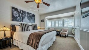 A bedroom with a large bed, a ceiling fan, and a window with blinds. - Romantic King Room Near Calistoga Spa & Hot Springs. (Calistoga)