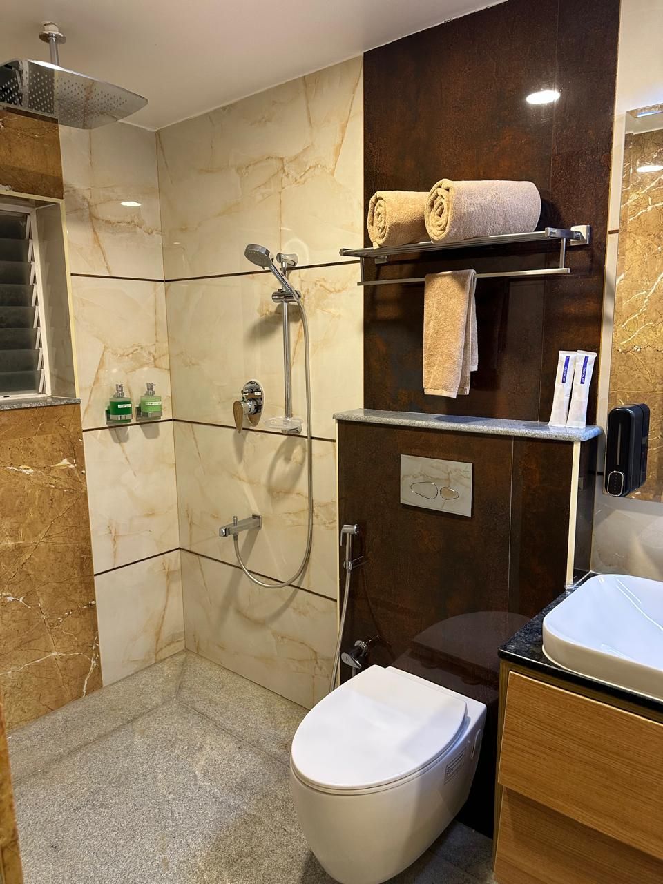 A modern bathroom with a shower, toilet, and vanity.