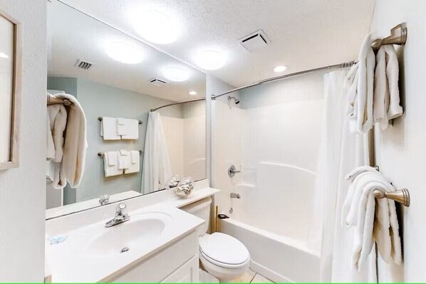 A bathroom with a sink, mirror, toilet, and bathtub. - Great Fall & Winter Rates; Refreshed Ground Floor Unit Steps to Beach and Pool. (Orange Beach)