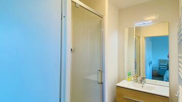 Shower, hair dryer, soap, toilet paper