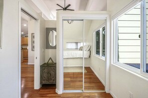 A bedroom with a bed, a dresser, a mirror, and a window. - Encinitas Paradise | Seabluffe Gated Community w/ Beach Access (Encinitas)