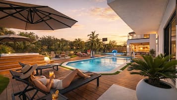 The pool is a spacious and inviting feature of the backyard, designed for both relaxation and fun. It includes a volleyball net stretched across the middle, perfect for games right in the water, see the amazing seats to relax while receiving the air