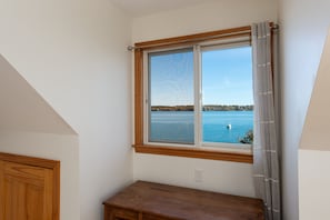 Enjoy a serene view of the calm body of water from this corner room's large window.