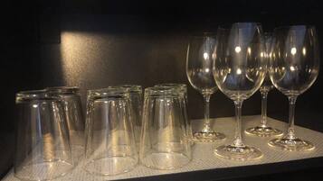 A row of empty wine glasses on a textured surface.