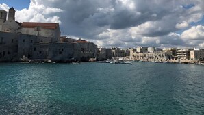 En kuststad med historiska byggnader och en klar, blå himmel.