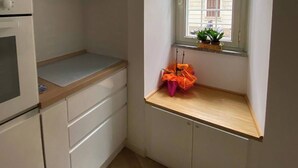 A small kitchen with a window, a built-in oven, and a wooden countertop. - Alice's apartment 1 (Roma)