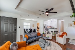 Relax in this stylish living space with a sofa, armchair, and coffee table.