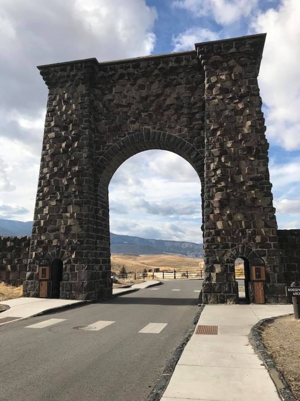 A stone archway with a road passing through it.