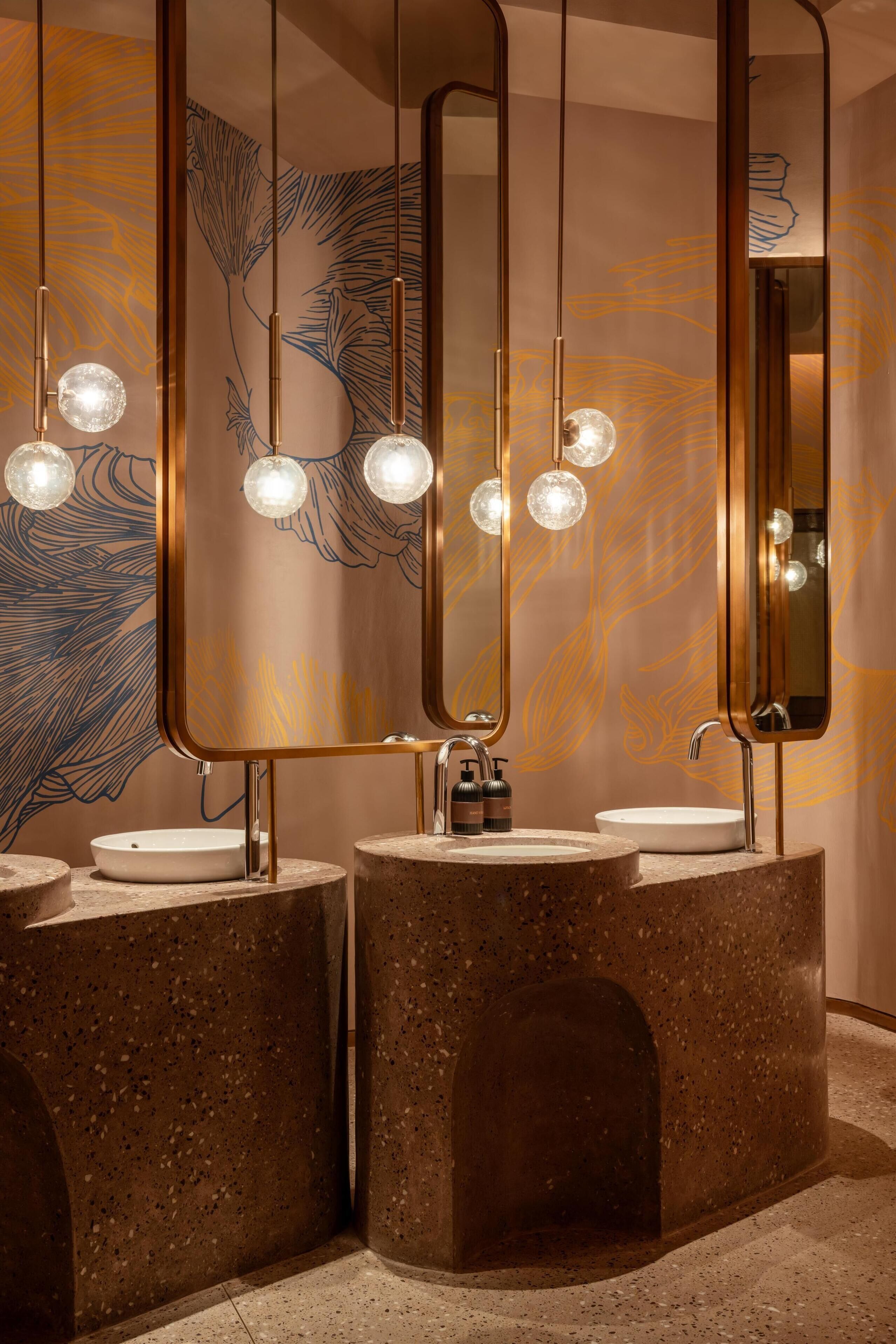 A bathroom with three sinks, each with a round basin and a mirror above.