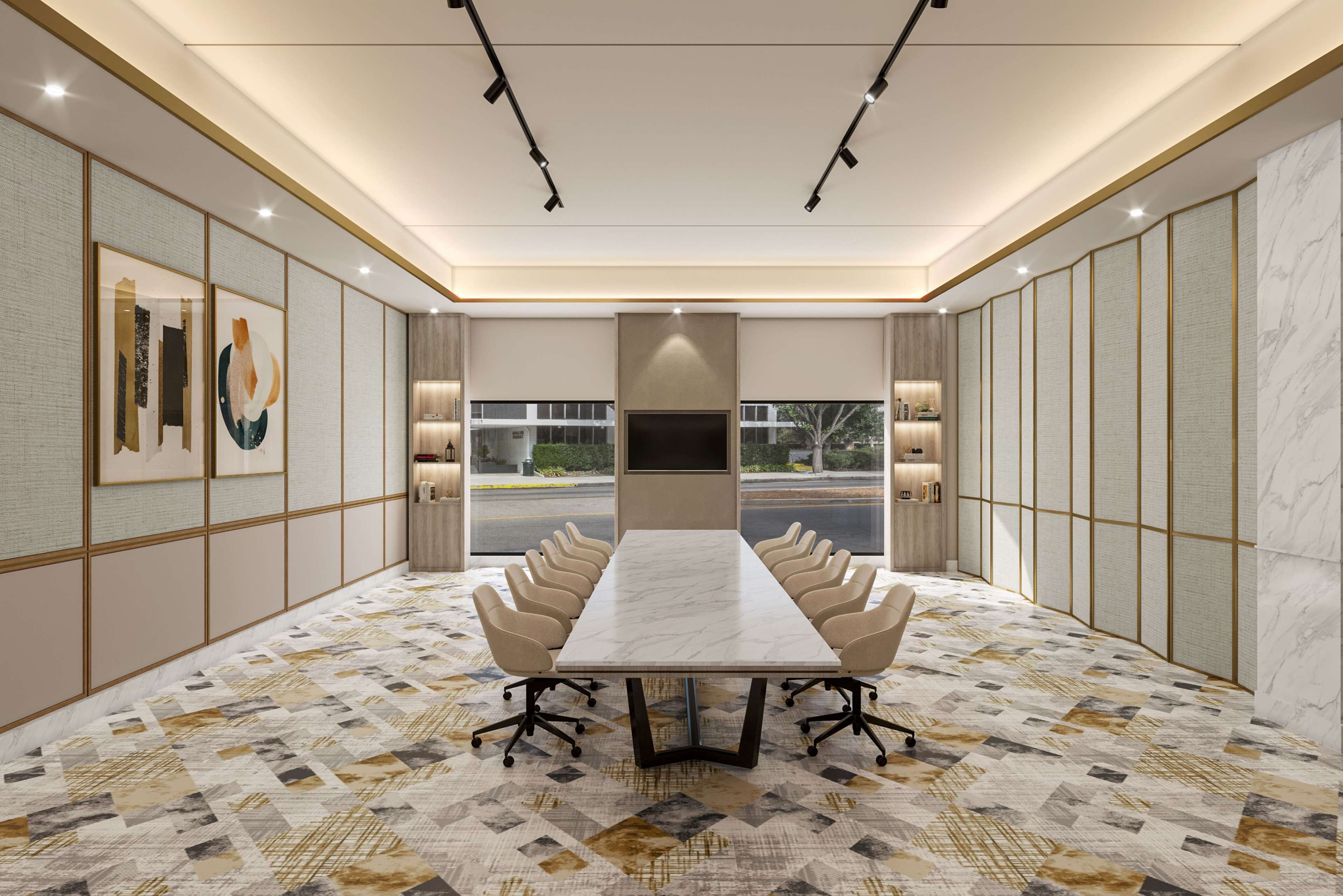 A conference room with a long table, chairs, and a large screen.