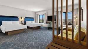 A hotel room with two beds, a desk, a chair, and a large window with a view. - Hampton Inn & Suites Corona, Ca (Corona)