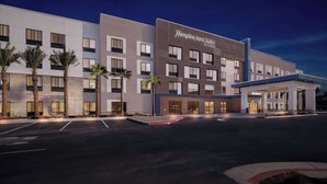 A modern hotel with multiple floors, a covered entrance, and a parking lot. - Hampton Inn & Suites Corona, Ca (Corona)