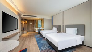 A hotel room with two beds, a TV, a desk, and a bathroom visible through an open door. - Holiday Inn Express Luoyang Longmen by IHG (Luoyang)