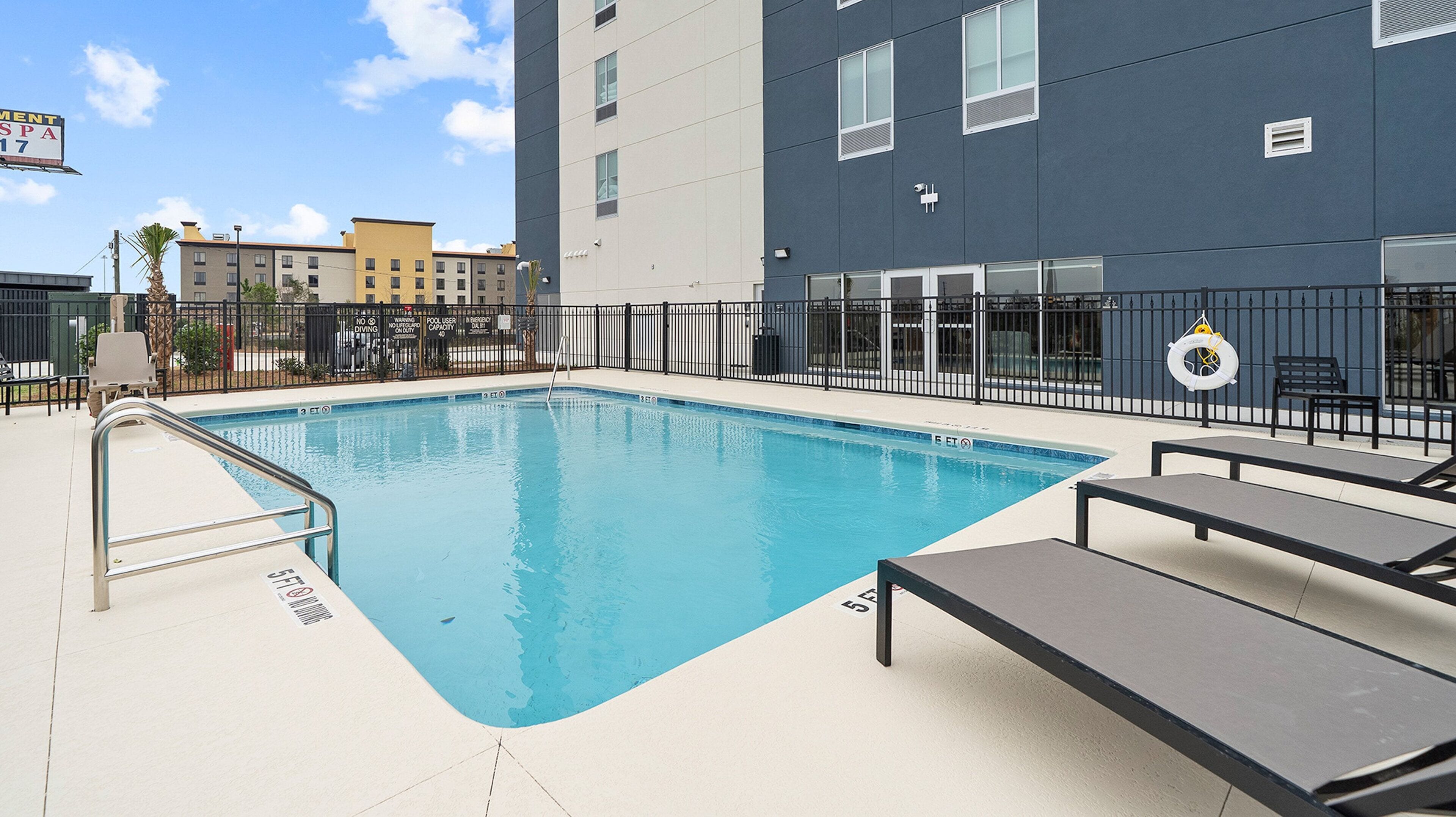 Seasonal outdoor pool, open 9:00 AM to 9:00 PM, pool umbrellas