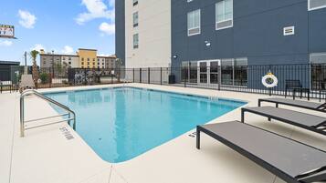 Seasonal outdoor pool, open 9:00 AM to 9:00 PM, pool umbrellas