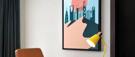 A modern office chair, a desk with a laptop, and a yellow desk lamp.