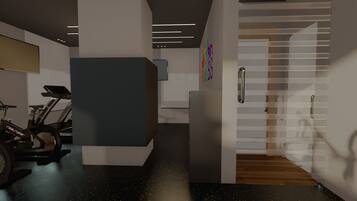 Ein modernes Interieur mit einem stationären Fahrrad, einem Empfangsschalter und einer Treppe, die in eine obere Ebene führt.