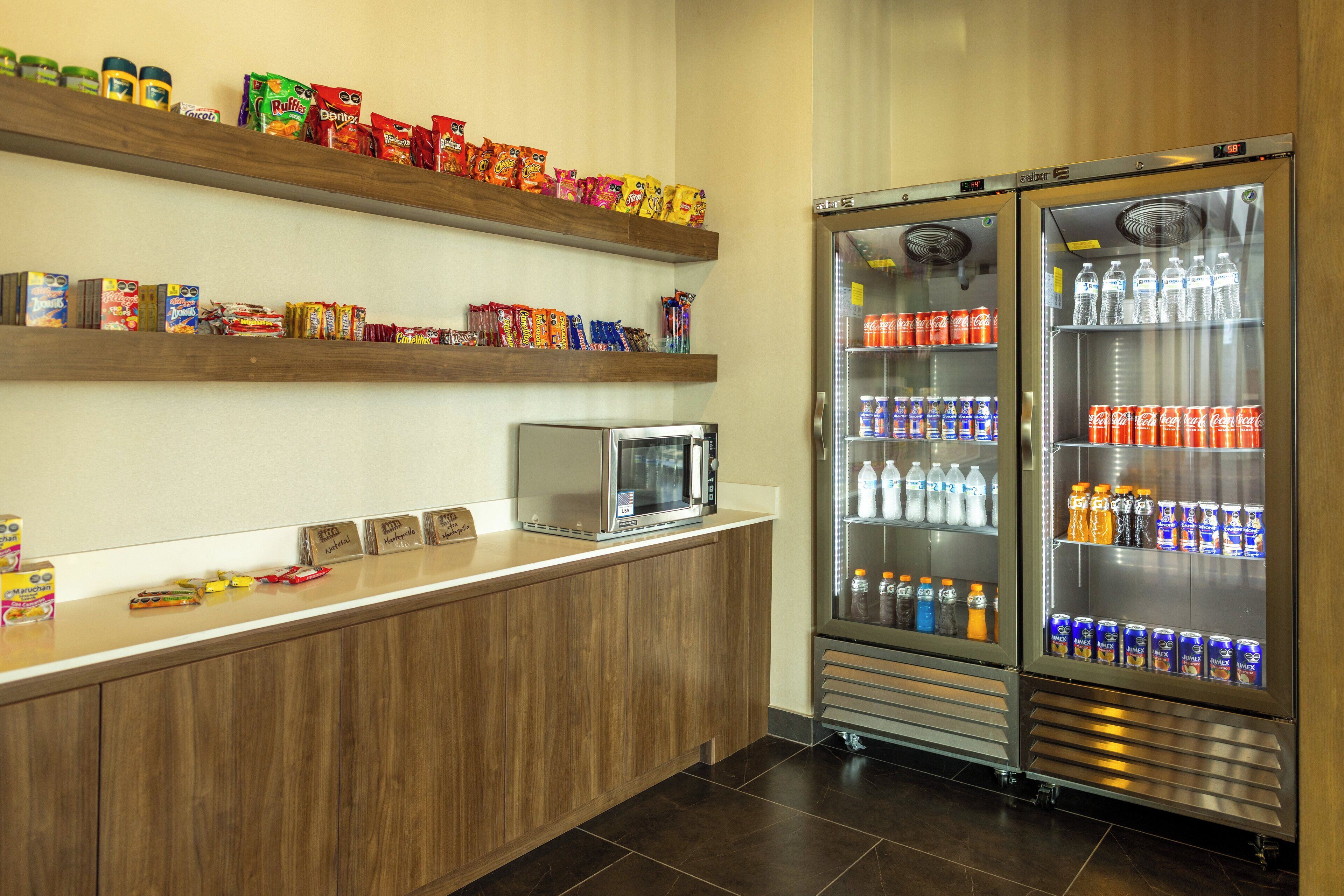 A vending area with snack options and a microwave on the counter.