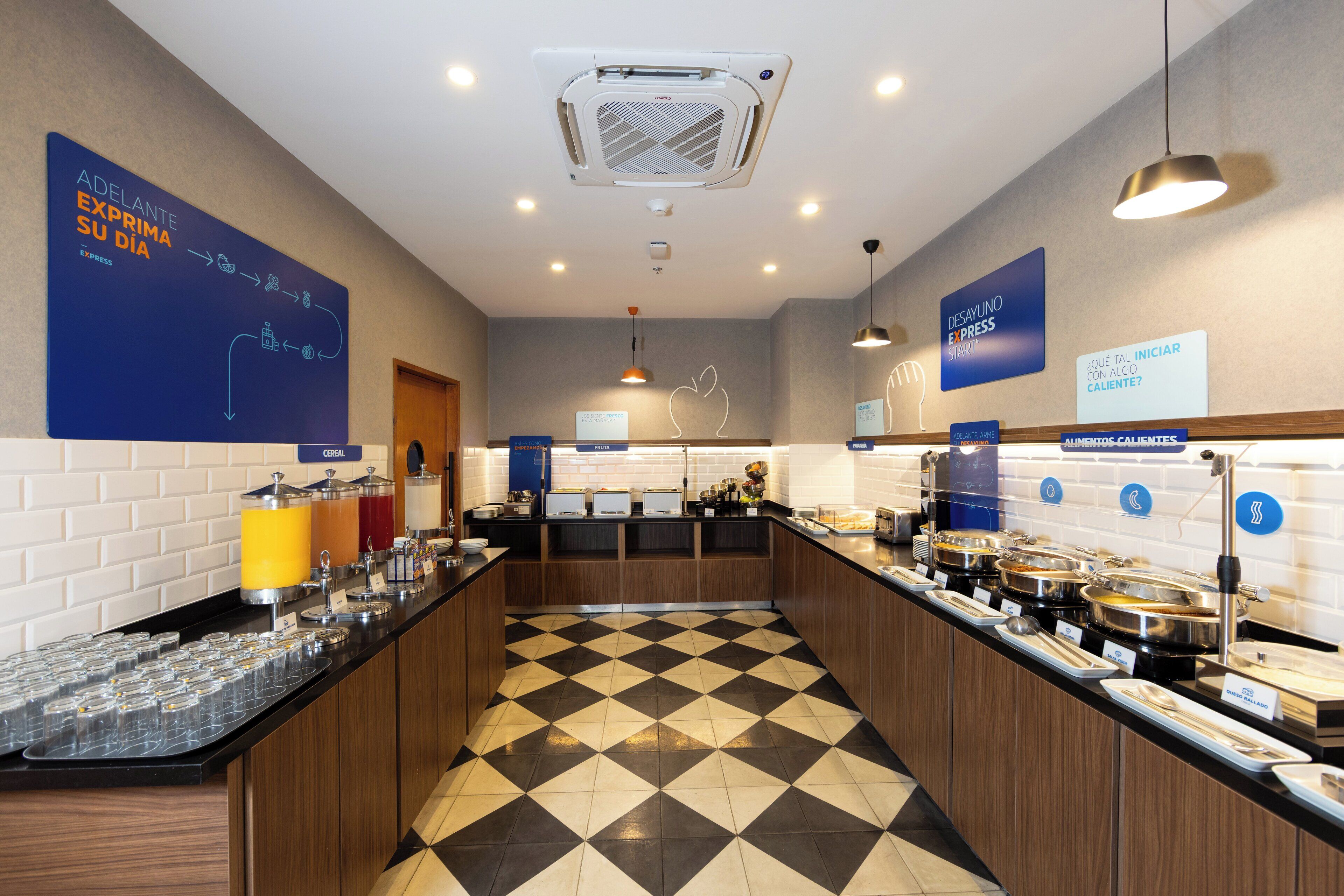 A buffet area with multiple food stations, a check-in counter, and a check-out counter.