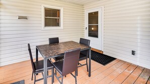 A covered patio with a table and chairs, a window, and a door. - 3 Mi to Huntington Beach: Hampton Family Home! (Hampton)
