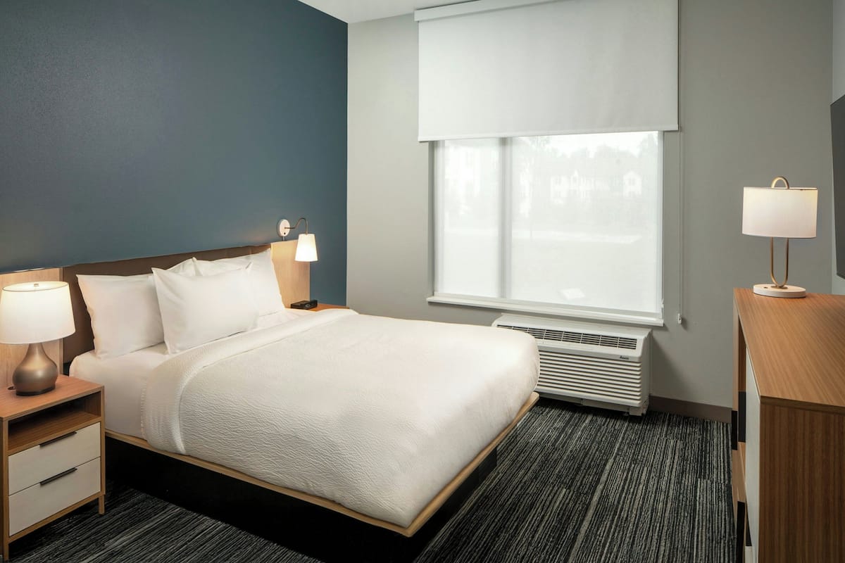 Hypo-allergenic bedding, desk, laptop workspace, blackout curtains