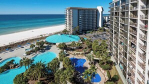 A hotel with multiple floors, a pool area with two swimming pools, and a beach view. - Turtle Cay Golf Villa Edgewater Beach Resort (Panama City Beach)