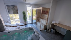 A modern spa room with a hot tub, a sliding glass door to a balcony, and a sauna area. - TESLA Residence Subotica (Subotica)