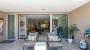 A spacious living area with a sofa set, a coffee table, and a gas stove. -  2 BR Chic Mid Century located in the heart of Palm Springs w/ stunning pool (Palm Springs)