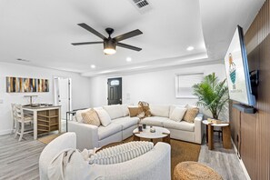Relax in this stylish living room with a sofa, coffee table, and armchair, perfect for unwinding and enjoying the view.