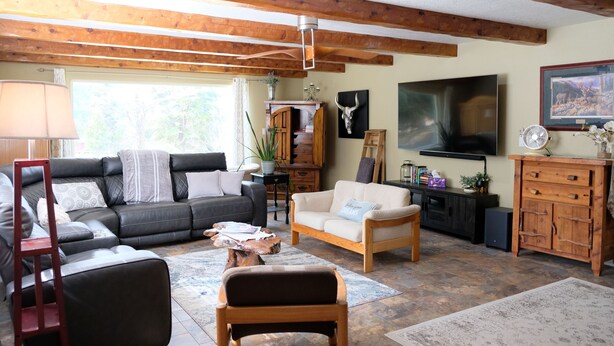A cozy living room with a sectional sofa, a wooden coffee table, and a fireplace. - Loveta Hideaway (Mount Shasta)