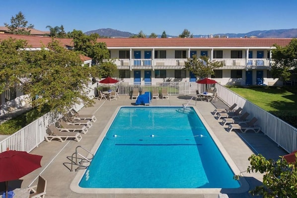 Una piscina al aire libre, sombrillas