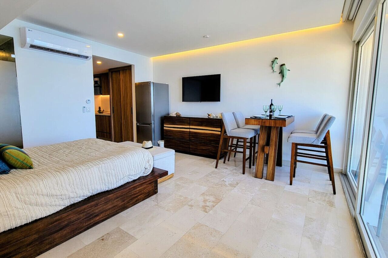 Une chambre à coucher moderne, avec un lit, un bureau et un téléviseur.