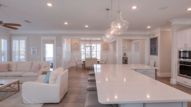 A spacious kitchen with a large island, modern appliances, and a dining area with a chandelier.