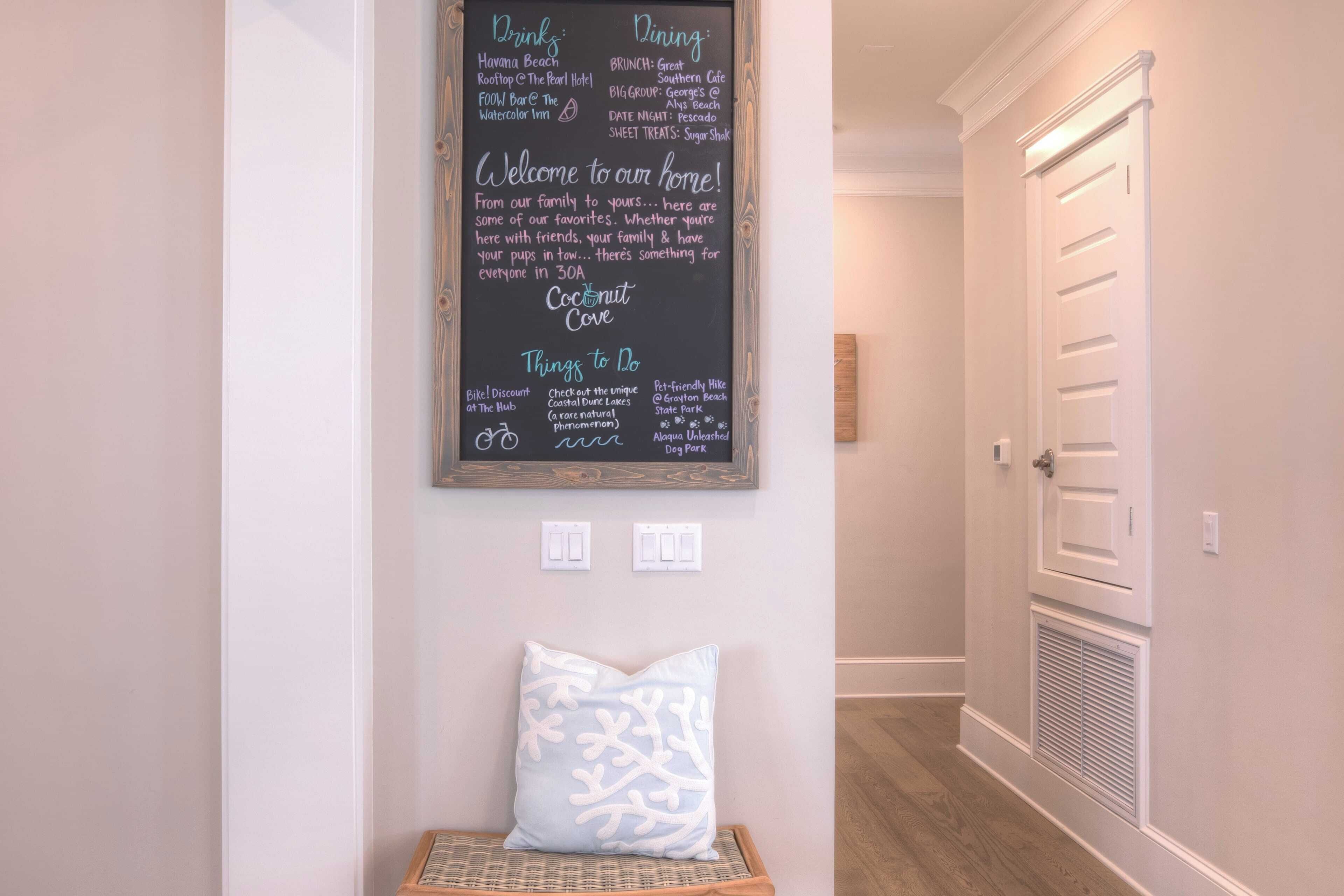 A chalkboard with a welcome message and a list of amenities including dining options and activities.