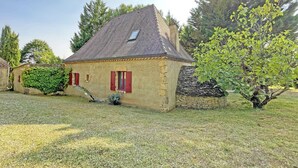 A single-story house with a sloped roof, a small window, and a chimney.