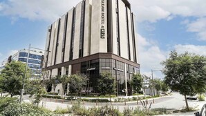 A modern hotel building with a prominent sign reading "The Glean Hotel & Dining". - The Gleam Hotel (Incheon)