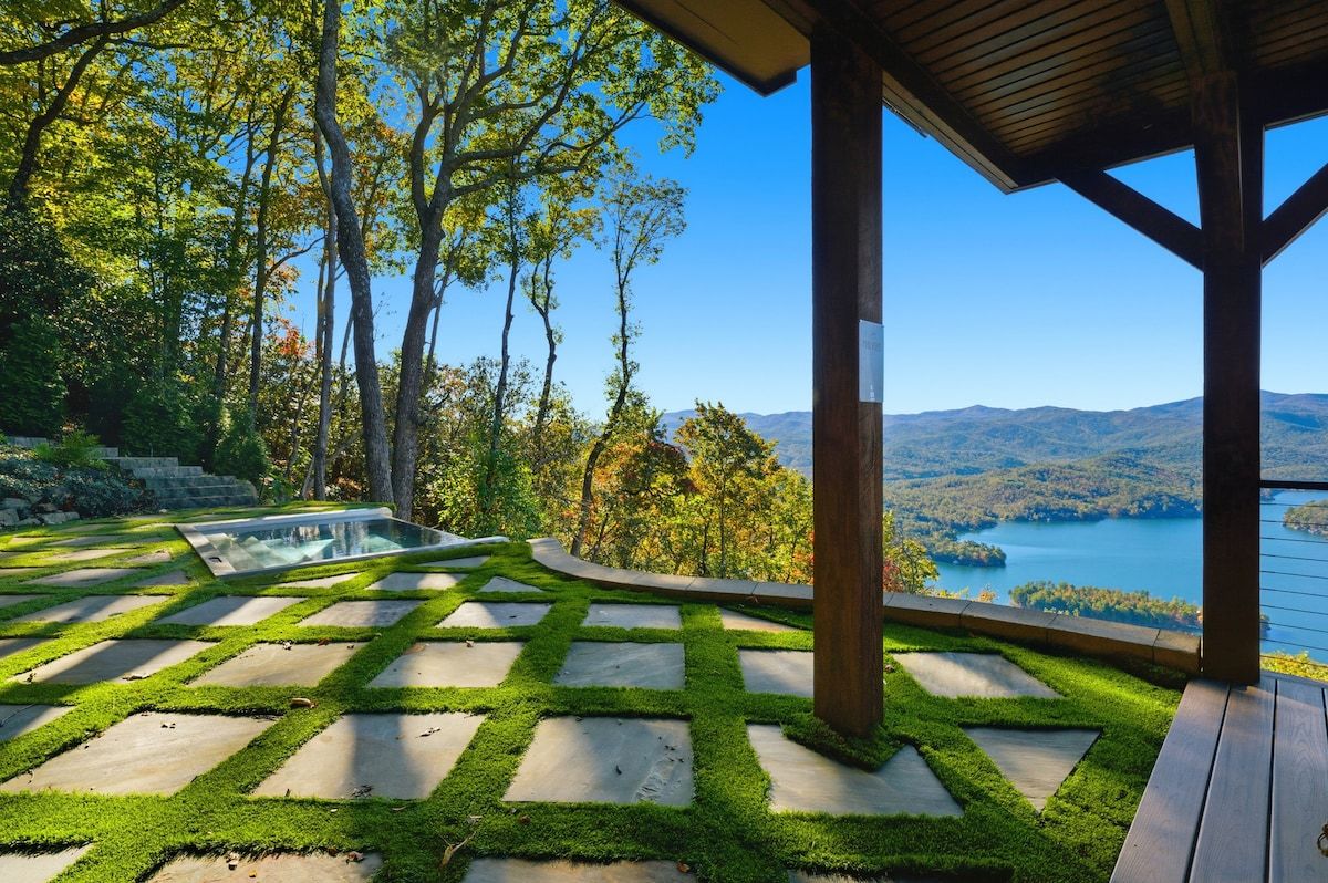 Lush green terrace walkways beneath the pergola — outdoor living spaces blend seamlessly with Blue Ridge Mountain nature at this Tiger, Georgia Lake Burton luxury vacation rental.
