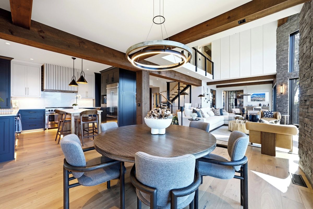 Elegant round dining table seats 10 comfortably — gather the whole group for family-style meals in this open-concept dining space at Lake Burton.