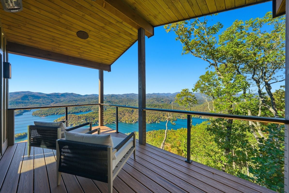 Private covered balcony off Bedroom 1 with panoramic Lake Burton & Blue Ridge Mountain views — wake up and step outside to pure mountain lake magic.